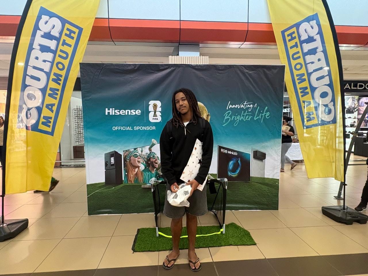 May be an image of text that says "COURTS MAMMOUTH M MAM A M M Hisense L FIFA OFFICIALSPONSOR OFFICIAL SPONSOR HTUON M TRύo3 A M /nnovating Life BrighterLife HTUOMMAM Brighter AM RGB MnikED"